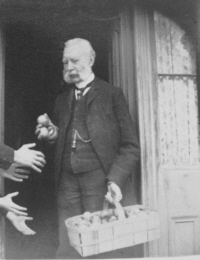 Robert Lees handing out apples at Halloween - before 1893