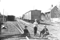 Bob Purdy and boys on rail at Main c1900