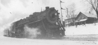 Locomotive with Harvey St. in background